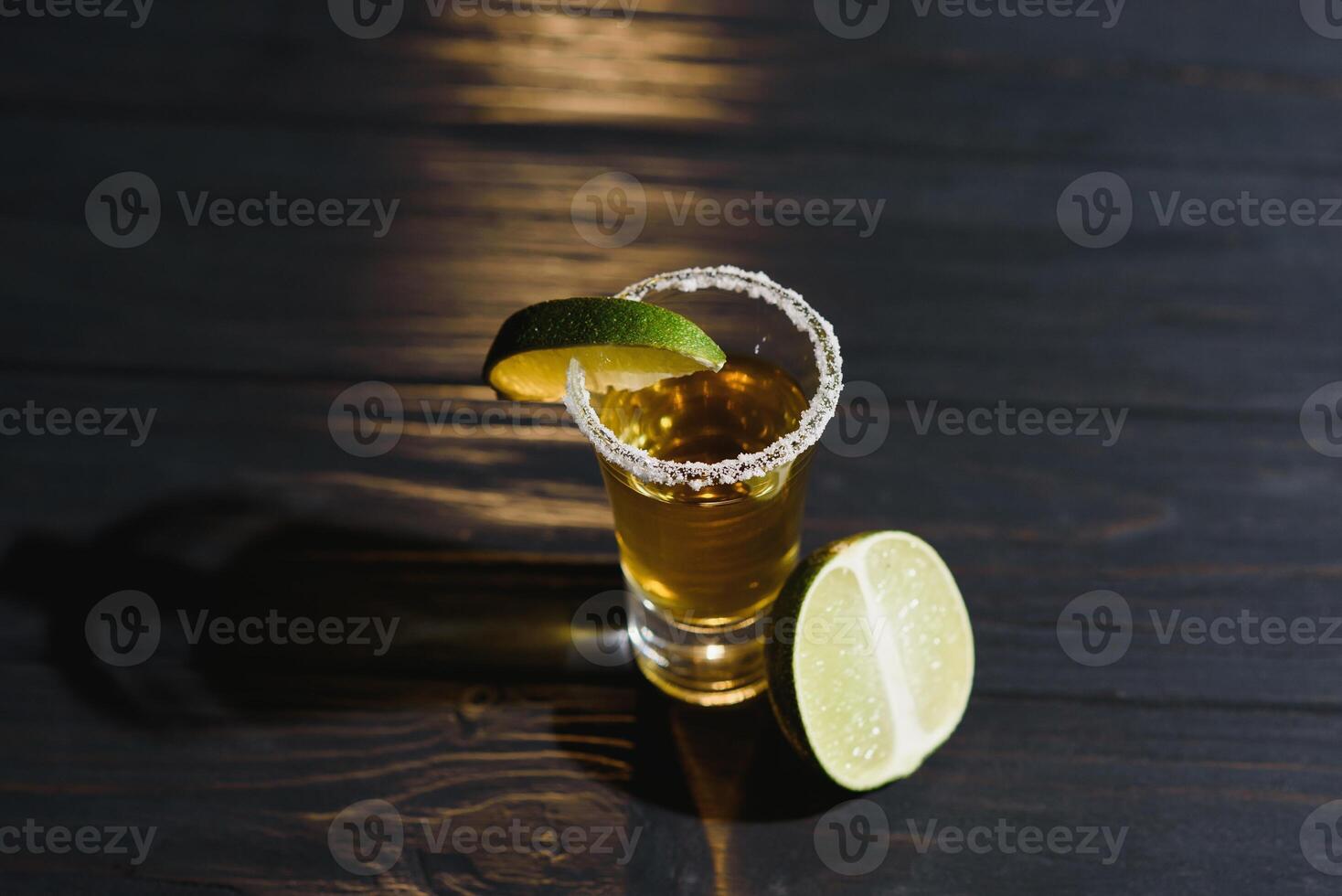 Mexican Gold Tequila with lime and salt on black background with copyspace. photo