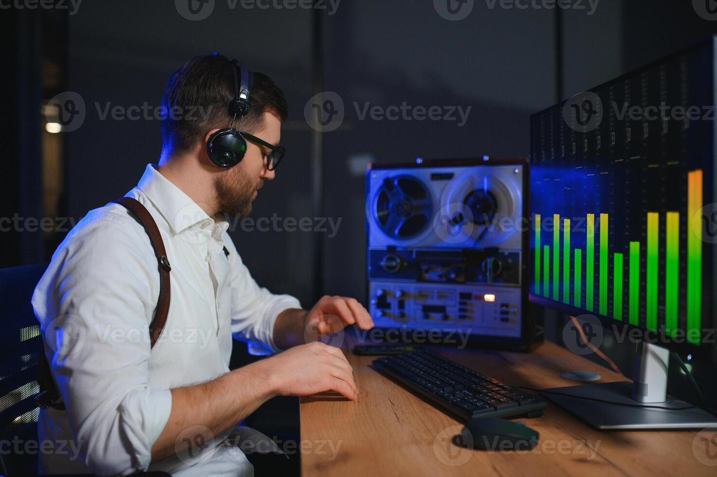 Secret agent listens on the reel tape recorder. Officer wiretapping in headphones photo