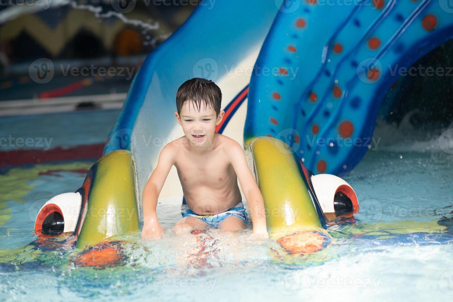 Boy having fun in aqua park photo