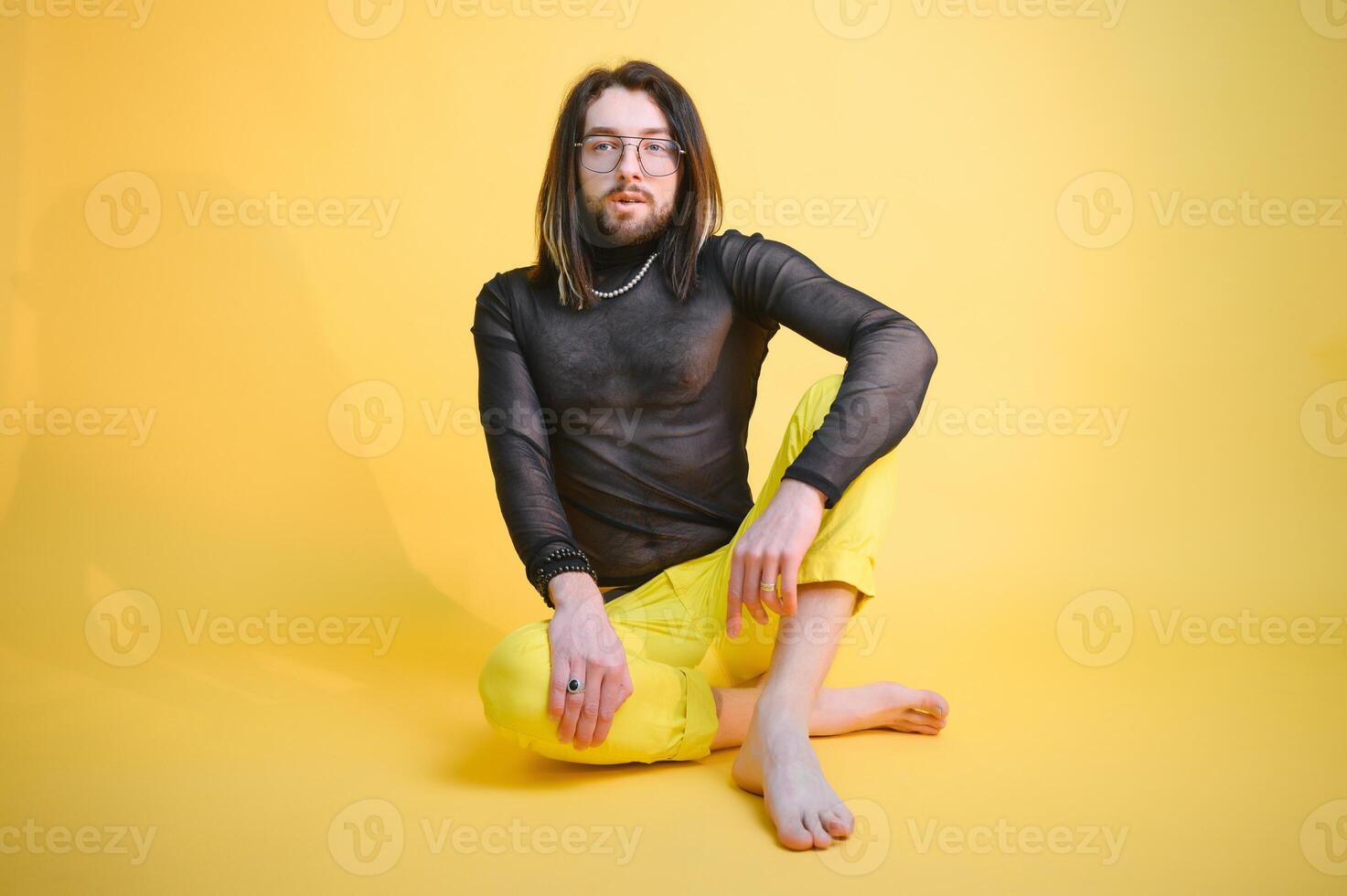 Young, handsome gay man on a colored background in the studio. LGBT concept. photo