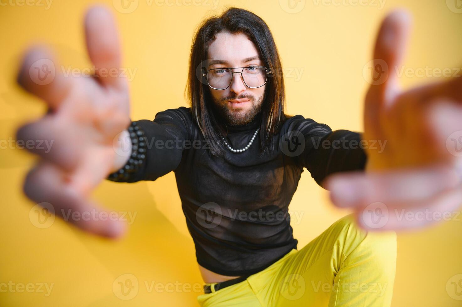 Gay man hold rainbow striped flag isolated on colored background studio portrait. People lifestyle fashion lgbtq concept photo