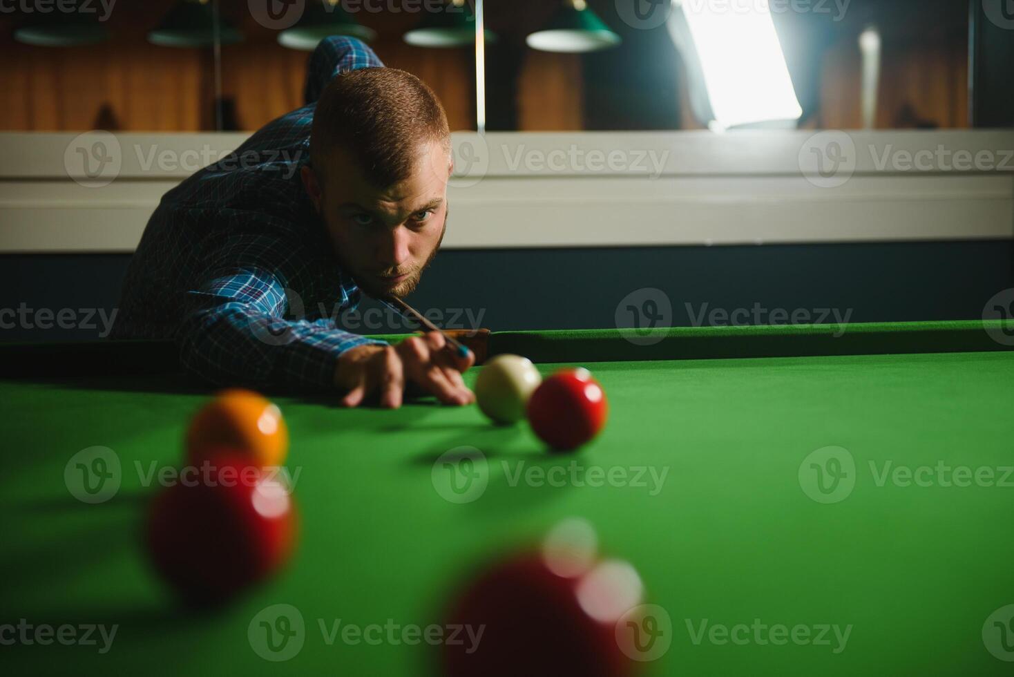 Playing billiard - Close-up shot of a man playing billiard photo