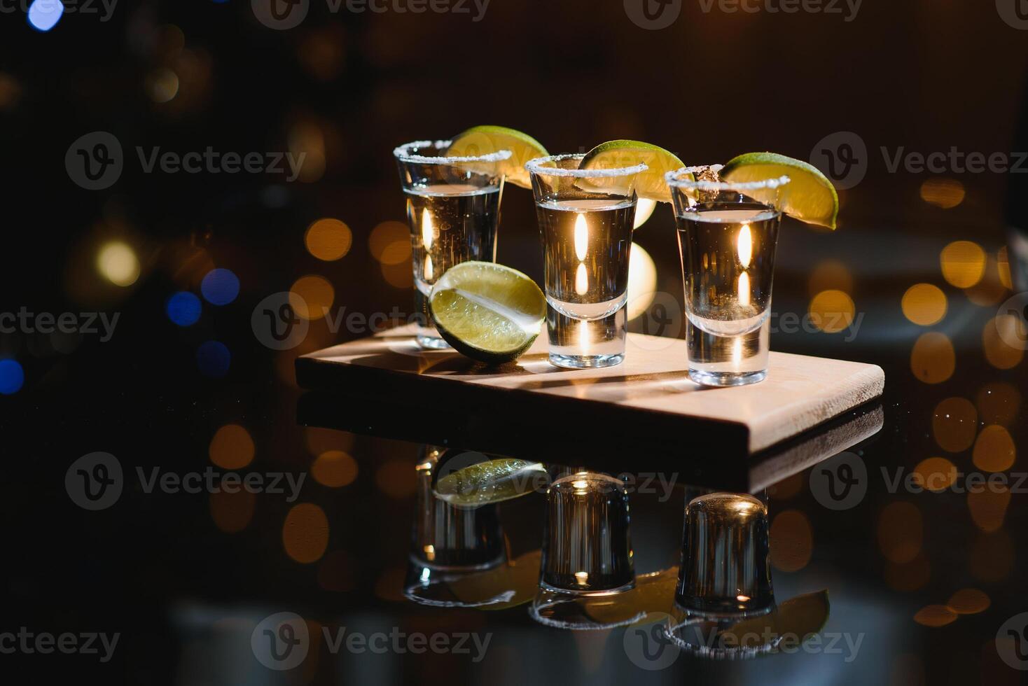 tequila with lime on a dark background photo