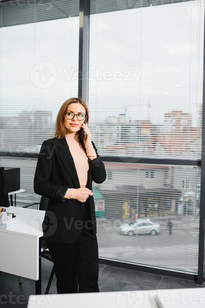 Portrait of smiling modern business woman in office photo