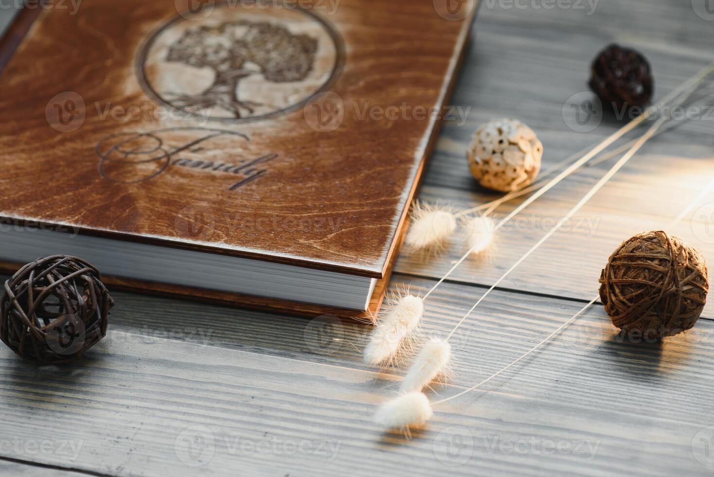 Luxury wooden photo book on natural background. Family memories photobook. Save your summer vacation memories. Photo album wedding photoalbum with wooden cover.