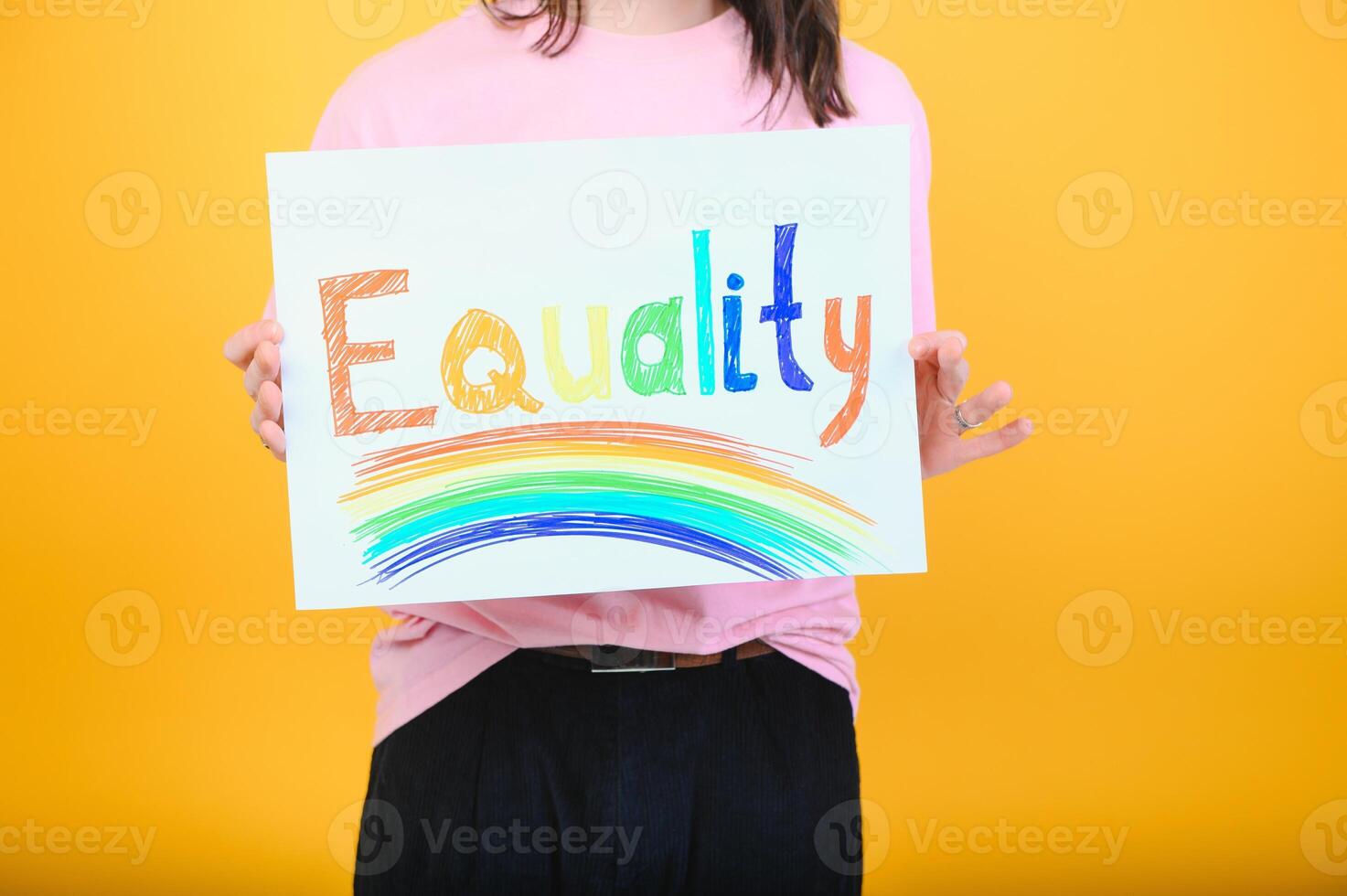 Hands of gay man holding lgbt banner on rainbow flag background lgbt symbol photo