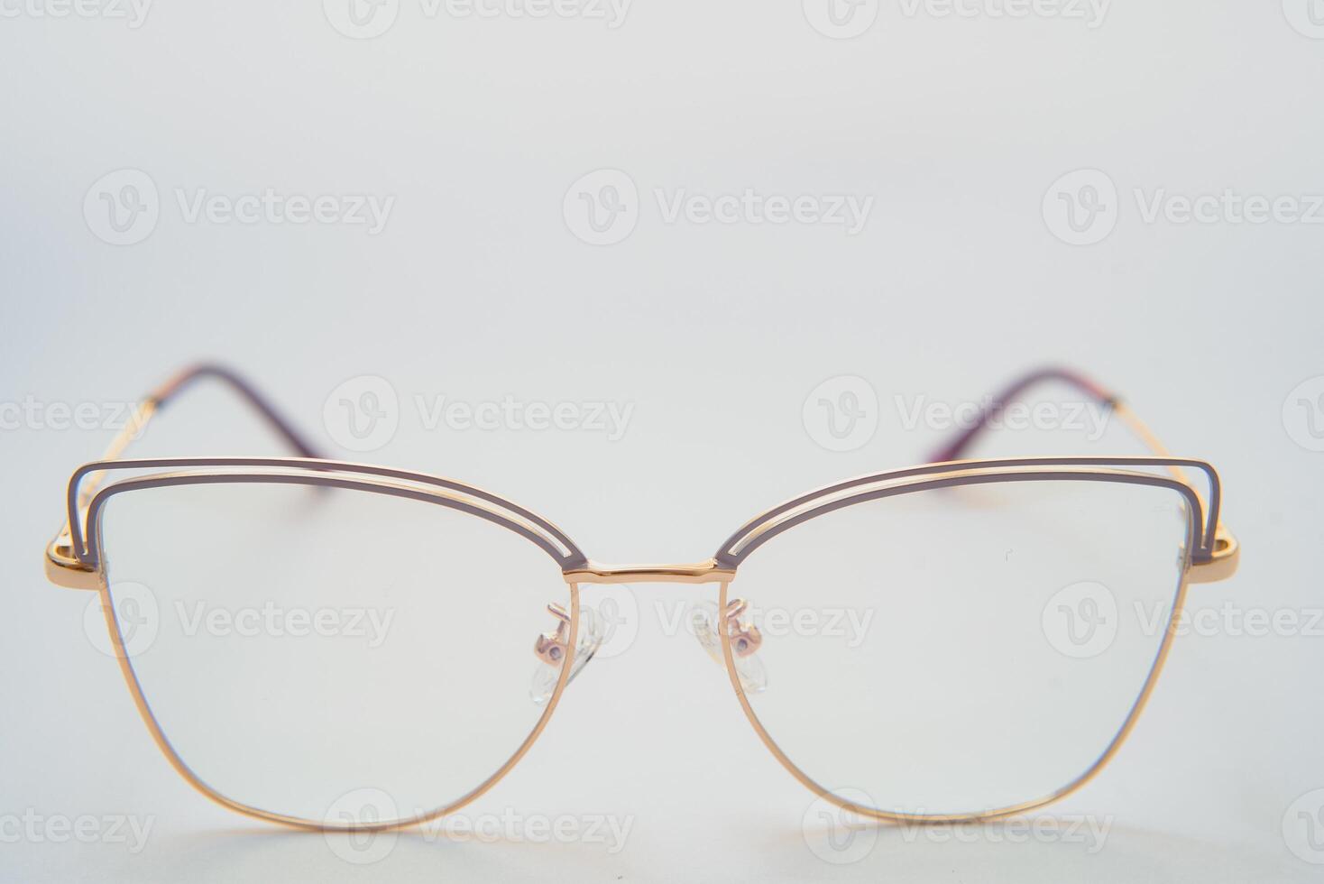 Female eyeglasses macro detail over a white background. Horizontal photo