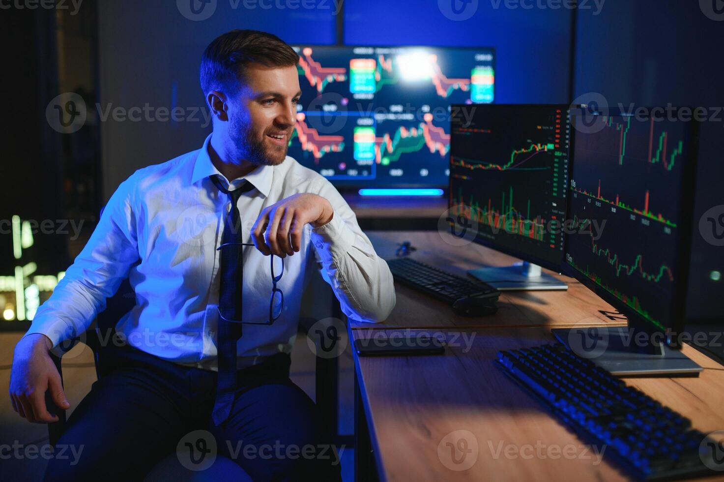 Financial Analyst. Businessman Works in Investment Bank Downtown Office at Night photo