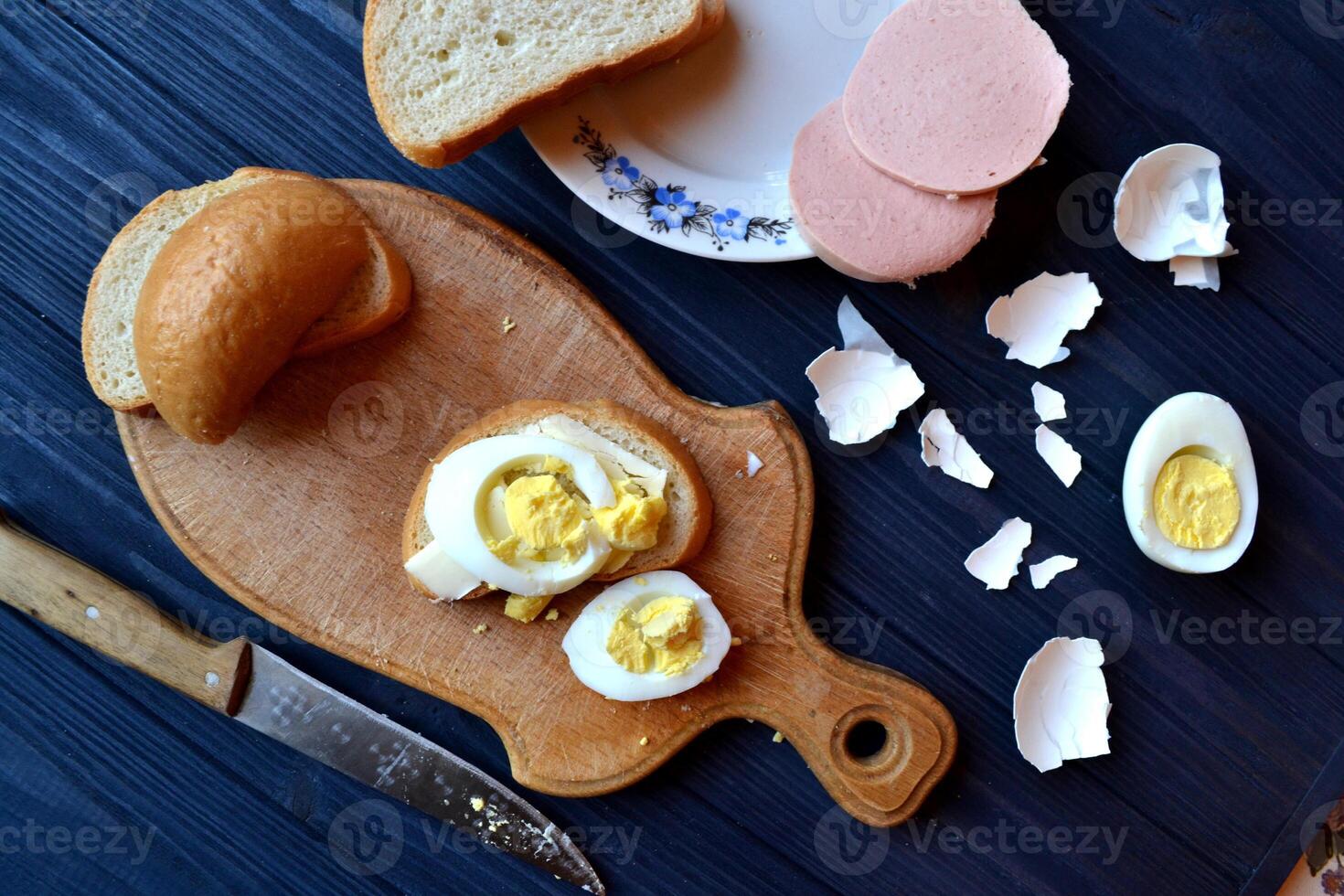Sliced eggs, eggs shell on a wooden board. Macro food photography. Homemade food still life. photo