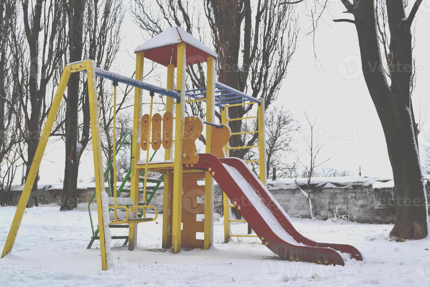 Winter playground kids. Snow in the street. Winter holiday. photo