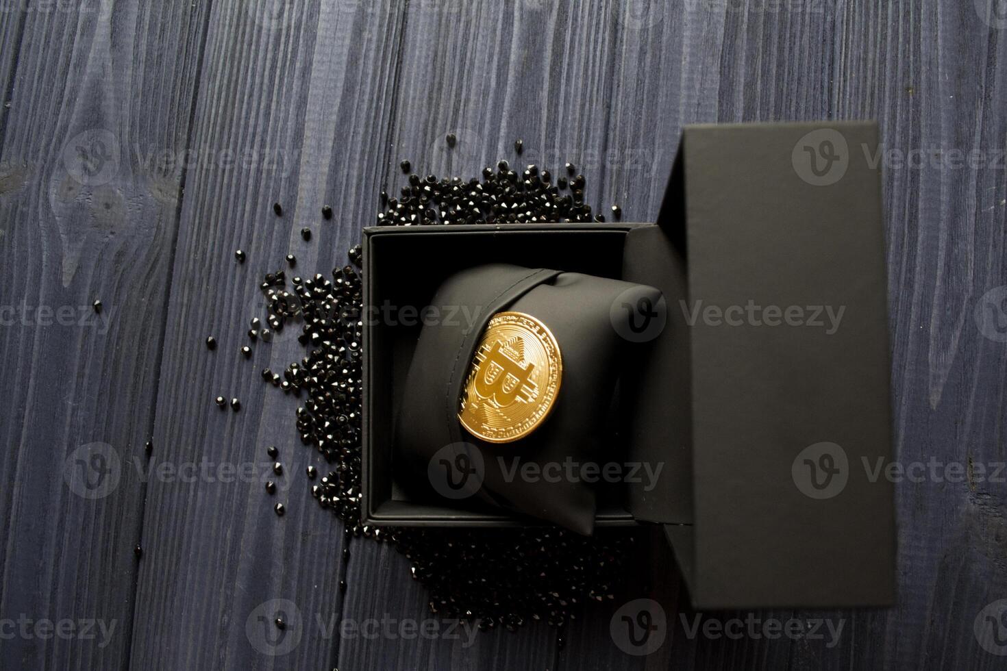 Golden bitcoin in a black box. Gold coin of cryptocurrency. photo