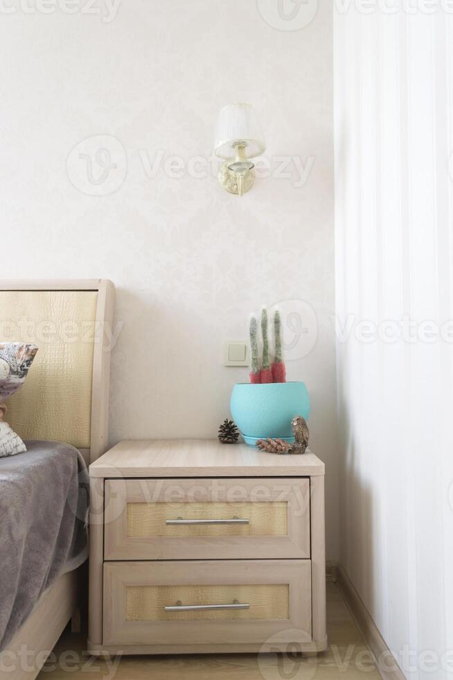 The interior of bedroom. The nightstand with home decor. photo