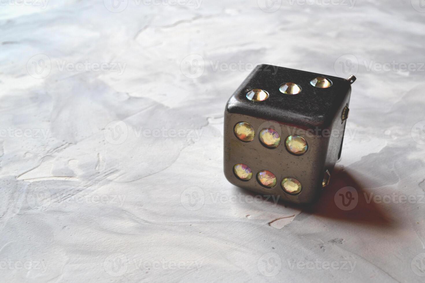 Dice cube with precious jewels on the table. Playing cube. photo