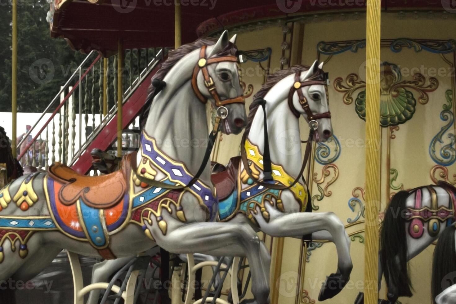 Vintage european carousel in a park. Merry go round horses. Retro style carousel. photo