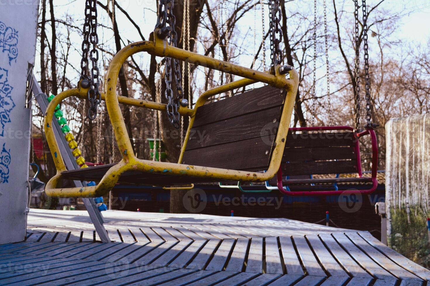 Old carousel in the park. Vintage swing at winter weather. photo