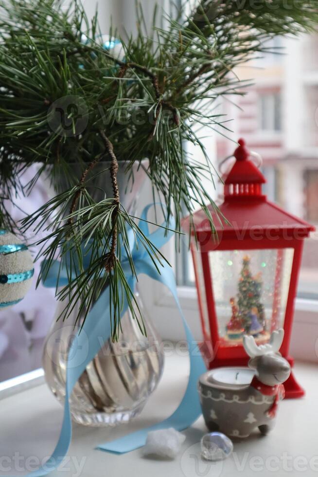 Red Christmas lantern and vase with pine tree. Christmas still life. Christmas decorations. photo