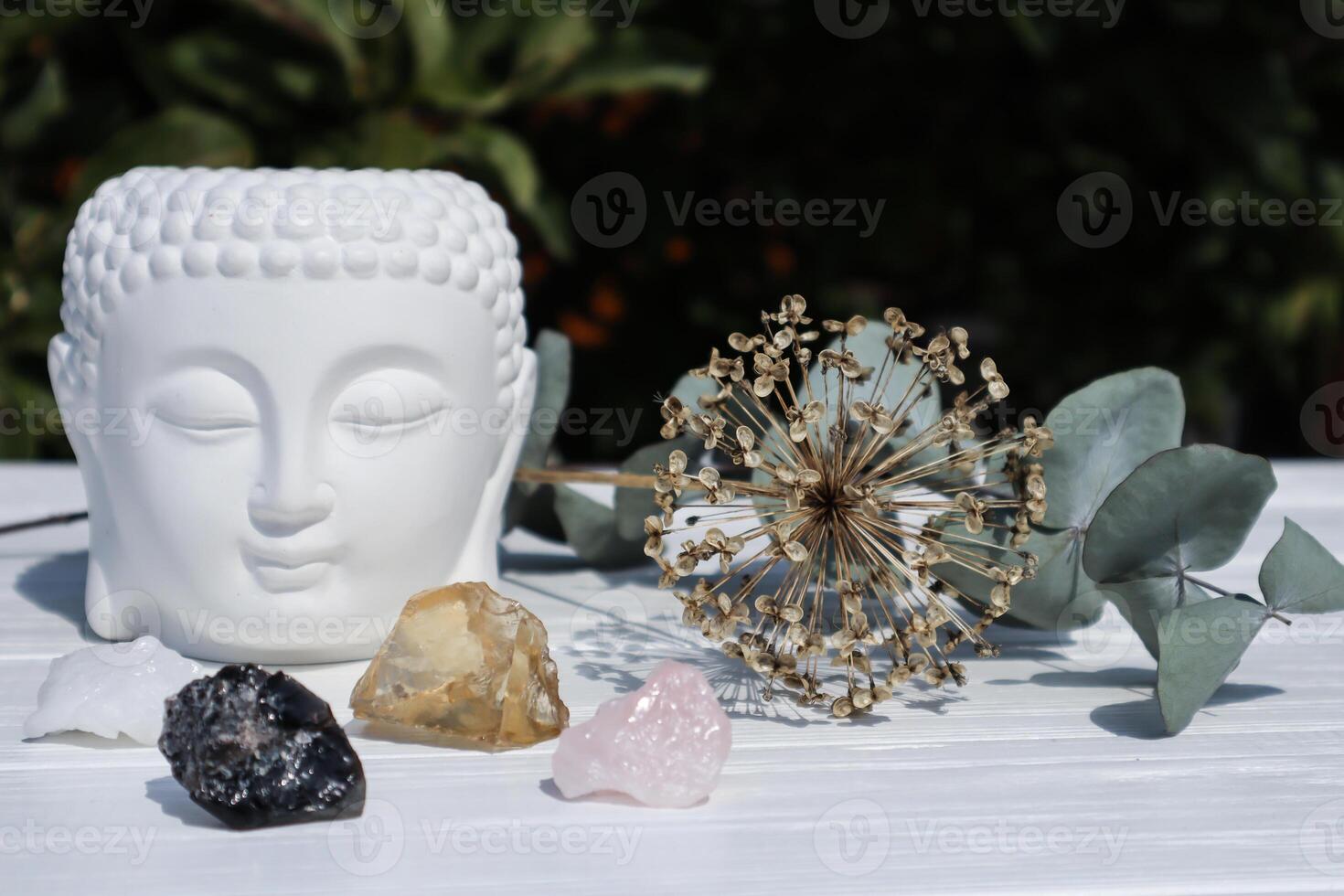 Altar with statue of Buddha and natural minerals. Morion, citrine and rose quartz at the sacred place. photo
