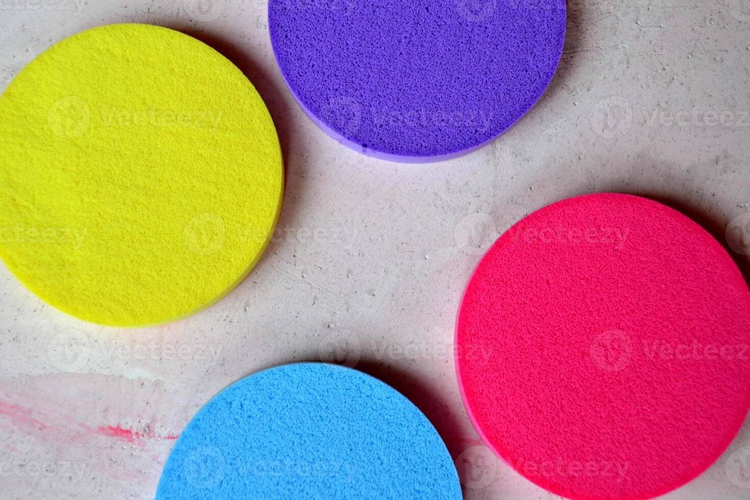 Colorful sponges on textured desk. Bright abstract background. photo