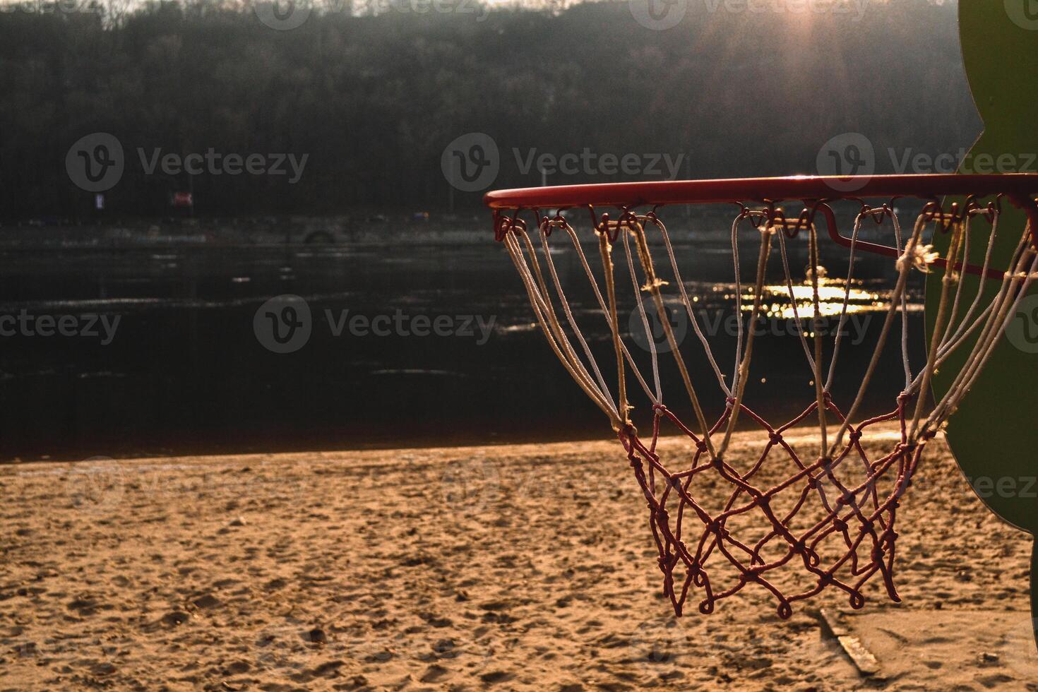 Basketball on the sunset beach. Basketball ring on the beach. photo