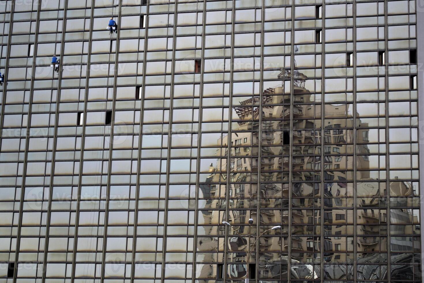 Distorted reflection of house in glass building. photo