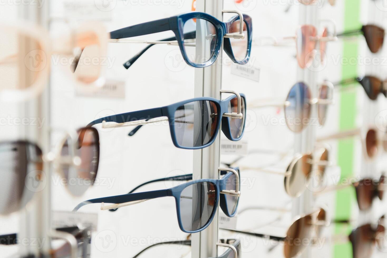 rack with glasses and sunglasses close up. photo