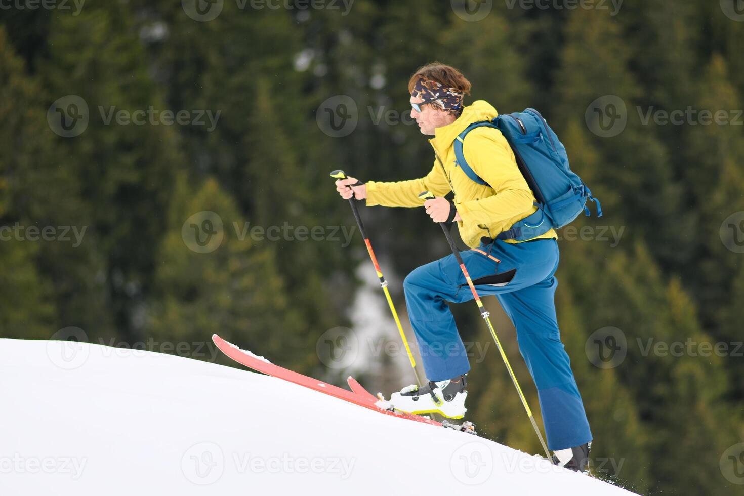 A man goes up mountain skis photo