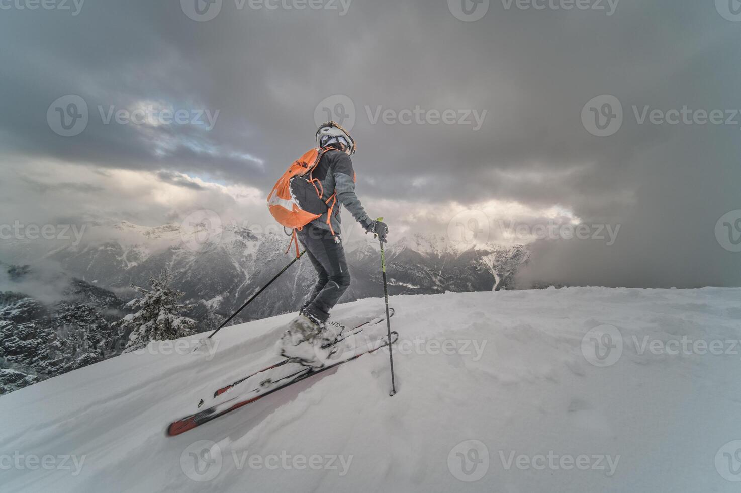 Little boy with mountaineering skis going uphill photo