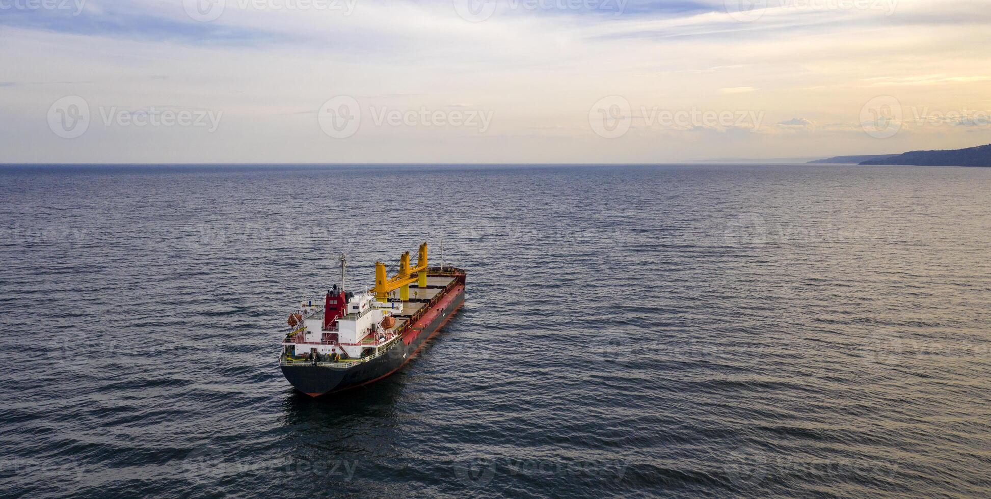 Large ship at sea. Aerial top view of cargo ship vessel import export sailing. photo