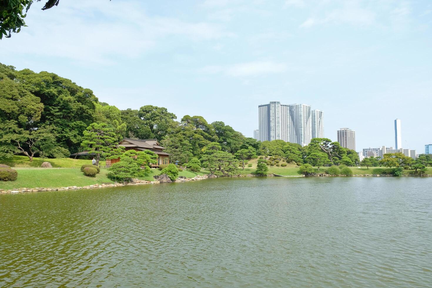 Traditional vs Modern Tokyo in Hamarikyu garden photo