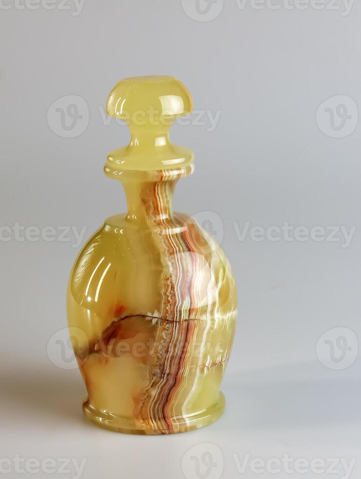 Handmade wine container made of natural onyx on a white background photo