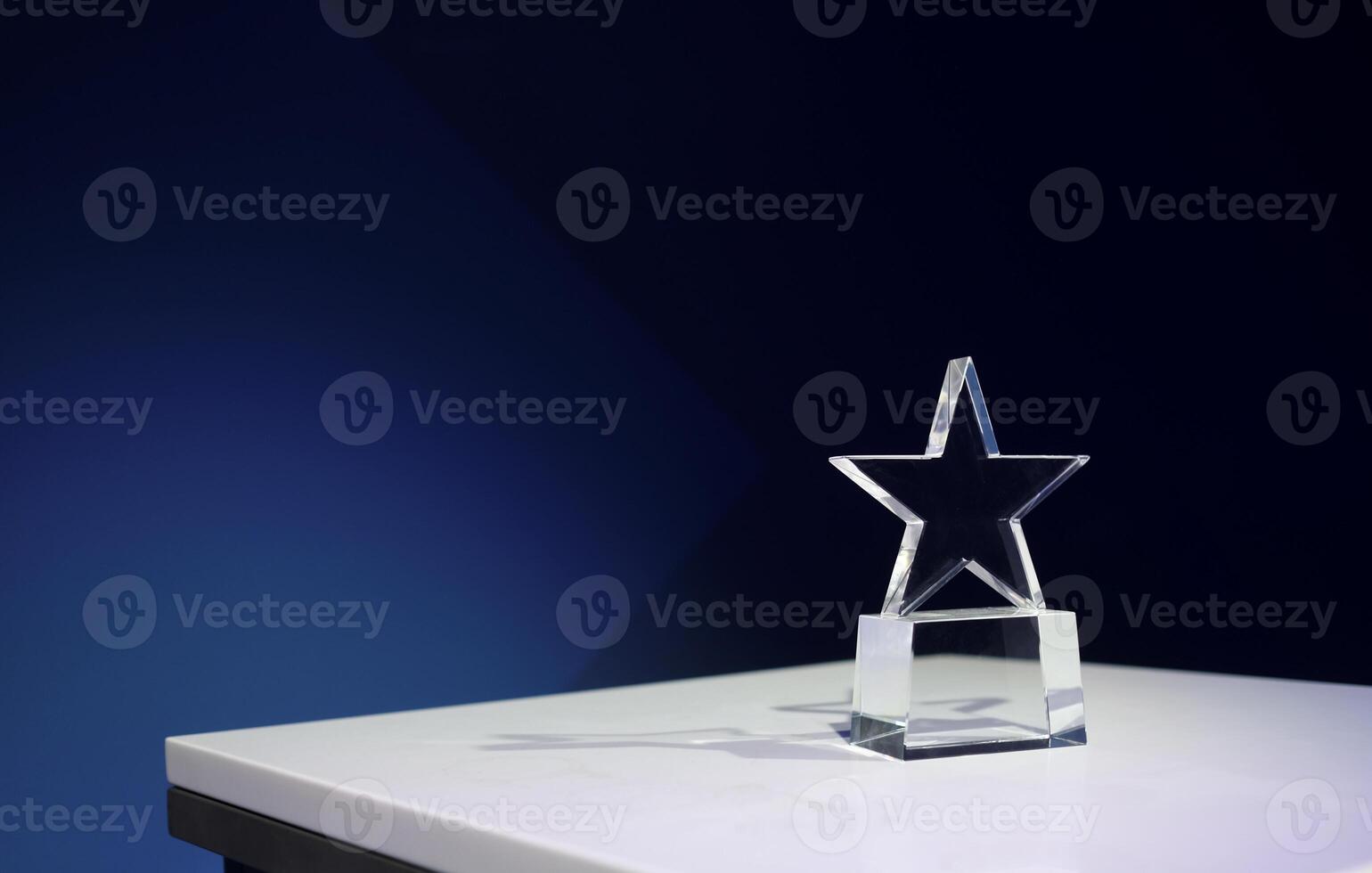 Star-shaped award on a table with spotlights and copy space photo