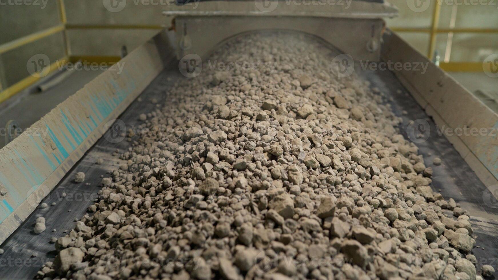 Close-up of bulk materials in a factory. Processing of raw additives in bulk at the plant. Crushed stone for addition to cement. Cement additives at the plant. photo