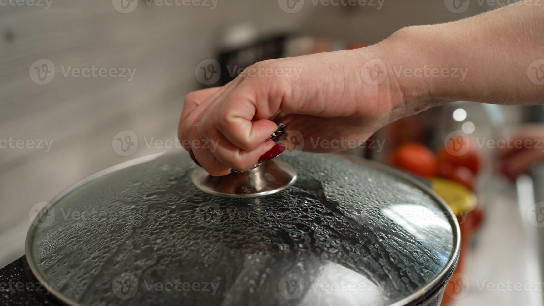 There is hot water in the pan, the pickles are prepared for rolling into jars. The process of salting jars, preparing for winter. The process of canning tomatoes for the winter. photo