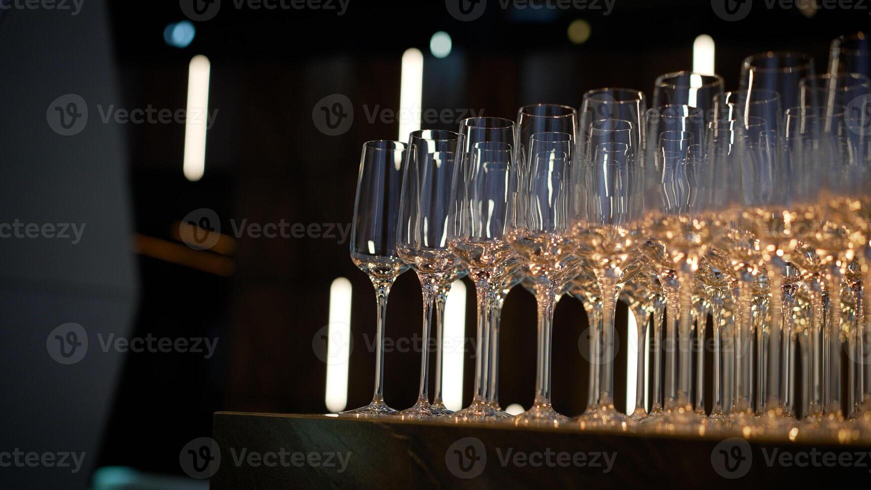 Champagne glasses are beautifully arranged at a wedding. Close up of several glasses beautifully arranged in a restaurant. Catering, beautifully arranged champagne glasses. photo