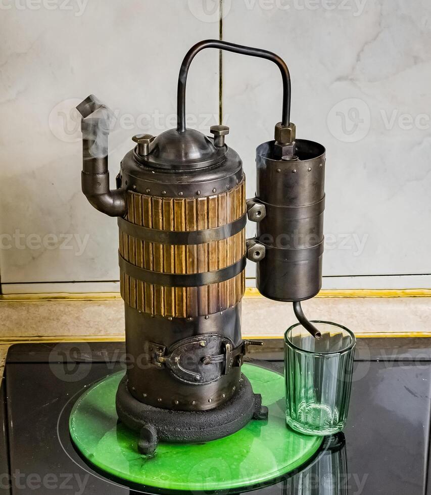 The process of distilling wine at a mini distillery using wood. Volume 400 ml. photo