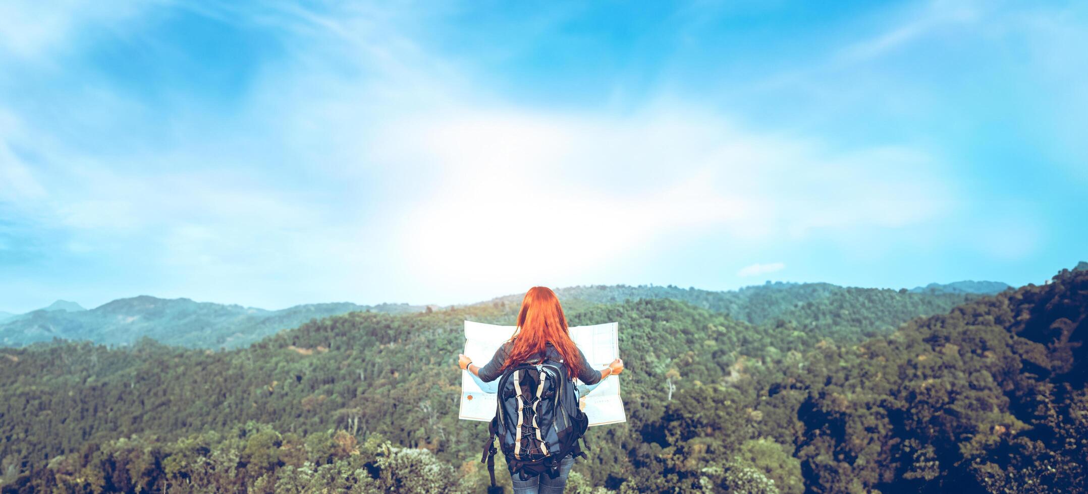 Travelers explore the mountainous forest map. photo