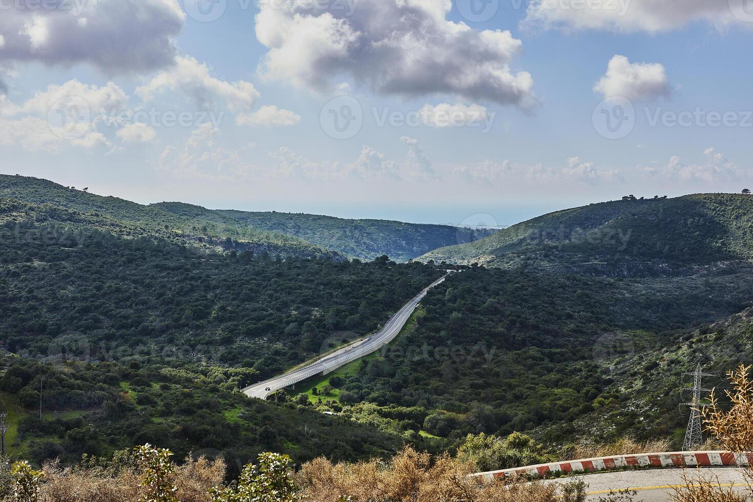 Peaceful Green Hills and Cloudy Blue Sky Landscape with Vibrant Colors photo