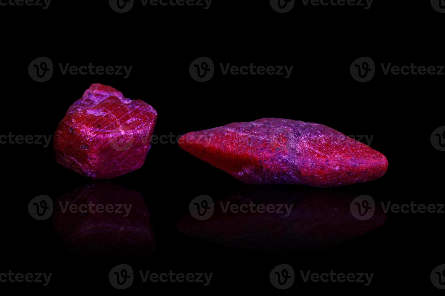 macro mineral stone ruby under ultraviolet light on a black background photo