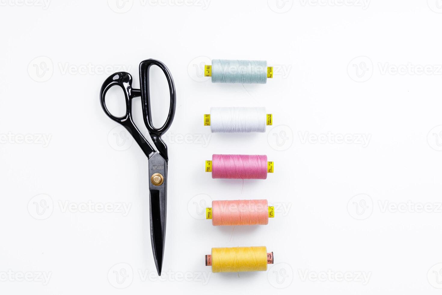 set of scissors for sewing and thread on a white background photo