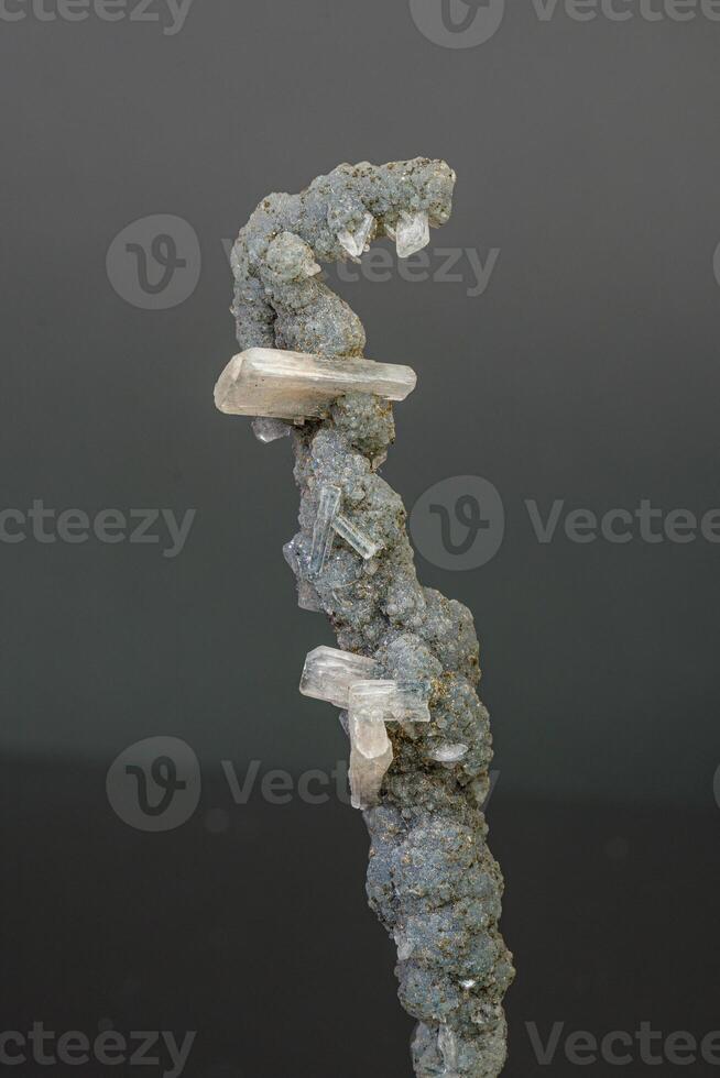 Macro mineral stone chalcedony with stelbite on a gray background photo