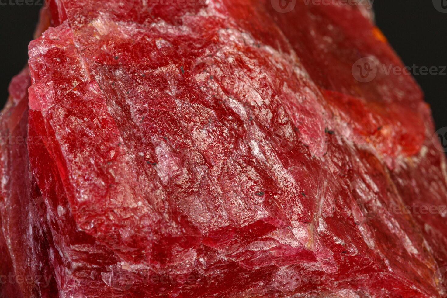 macro mineral Rhodonite stone on a black background photo