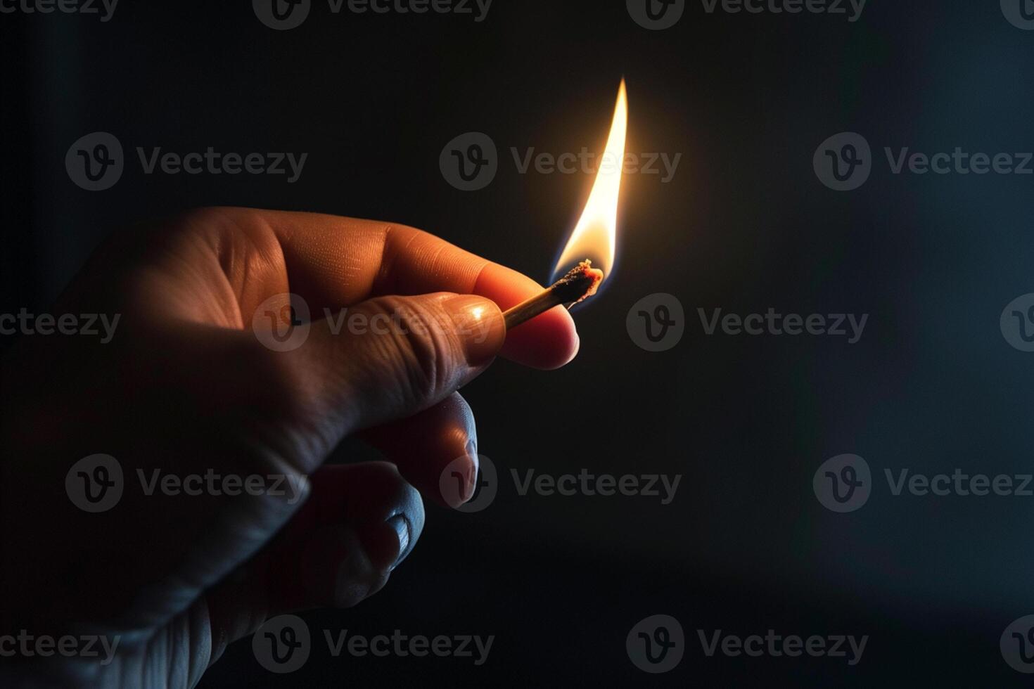 AI generated hand holds a burning match close-up on a dark background photo