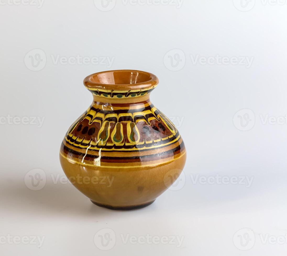Clay vase with painting for flowers on a white background. photo