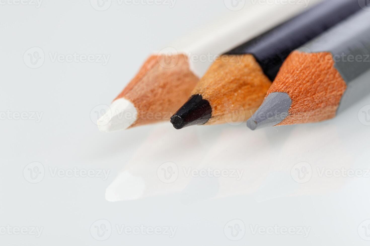 white, gray and black pencil on a white background photo