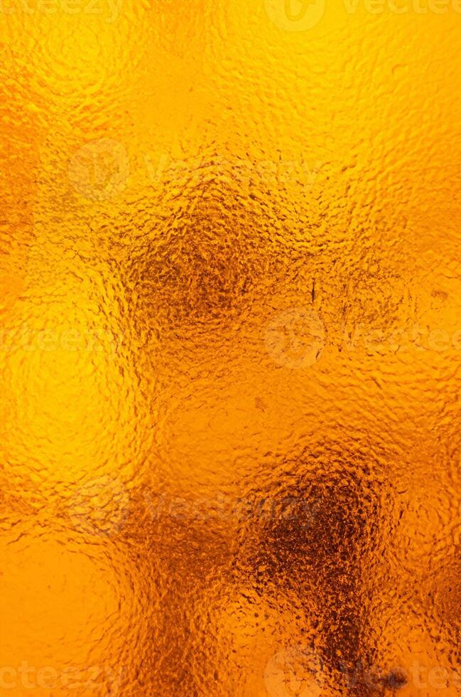 escarchado complejidad, hielo patrones en naranja vaso foto