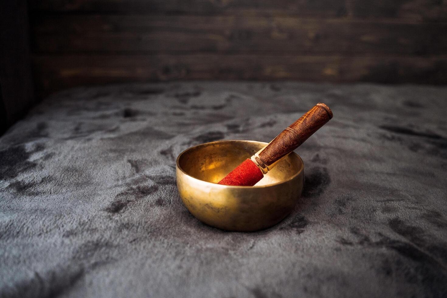 The Singing Bowl and Tibet. Musical instrument of ancient monks. Silence in meditation, yoga at home. The object emitting the gong, vibrations. photo