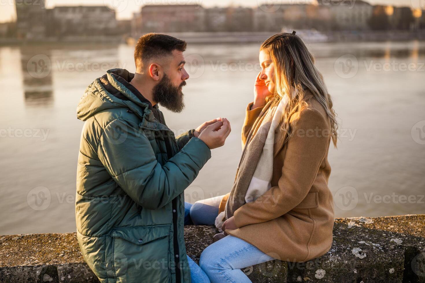 Couple having conflict and  they are arguing while sitting outdoor. photo