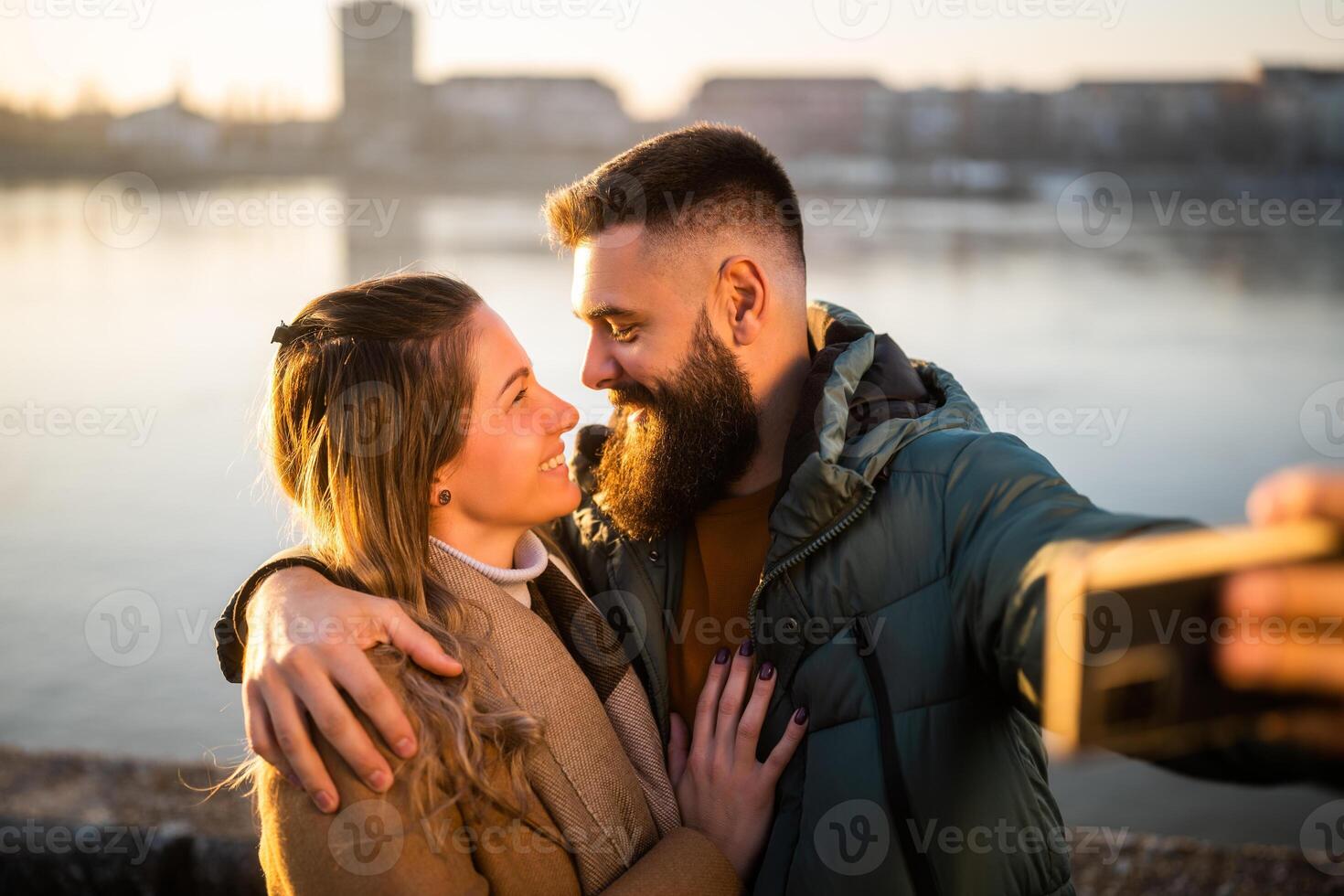 Close up image of happy couple taking selfie outdoor. photo