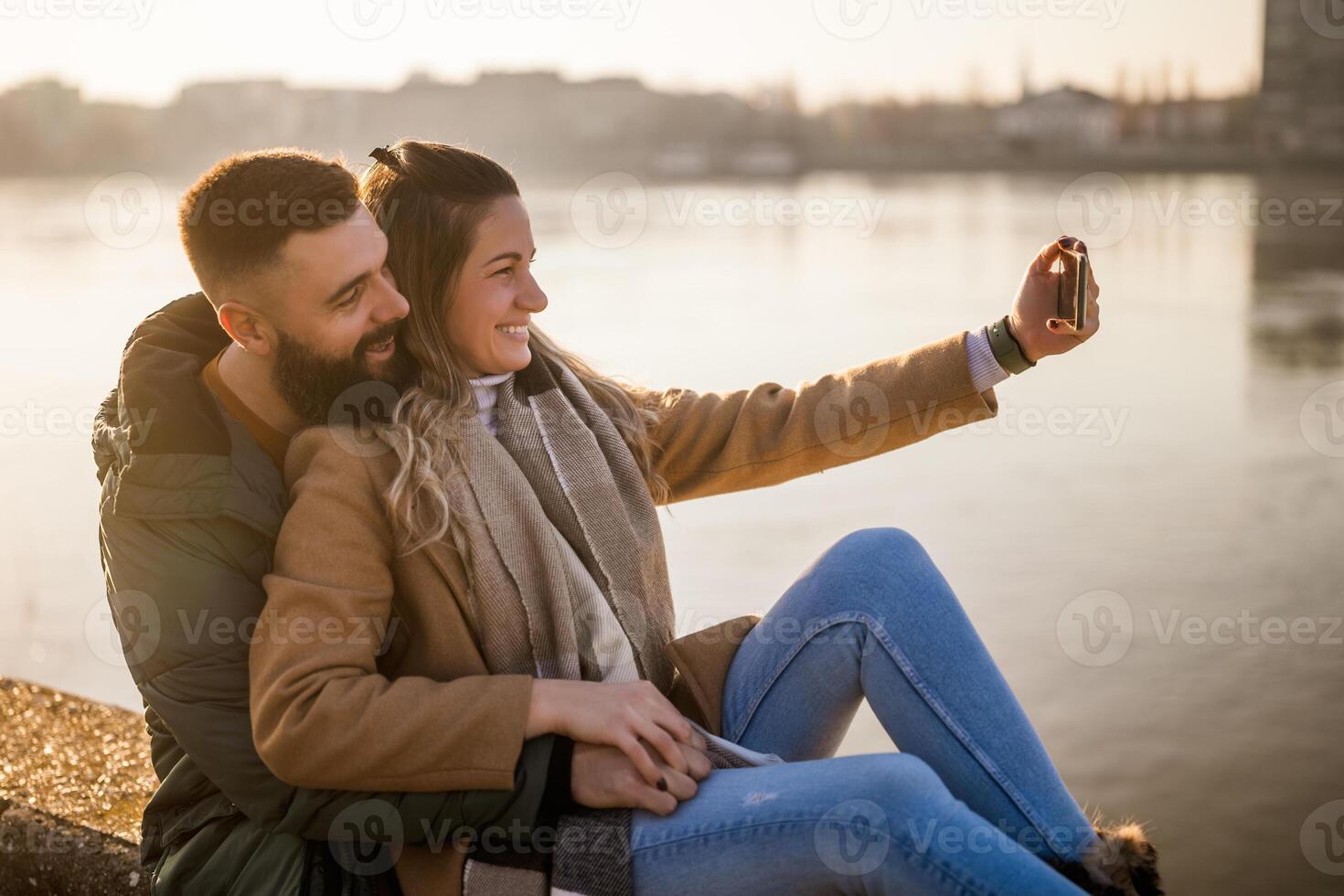 Happy couple taking selfie while enjoy spending time together outdoor. photo