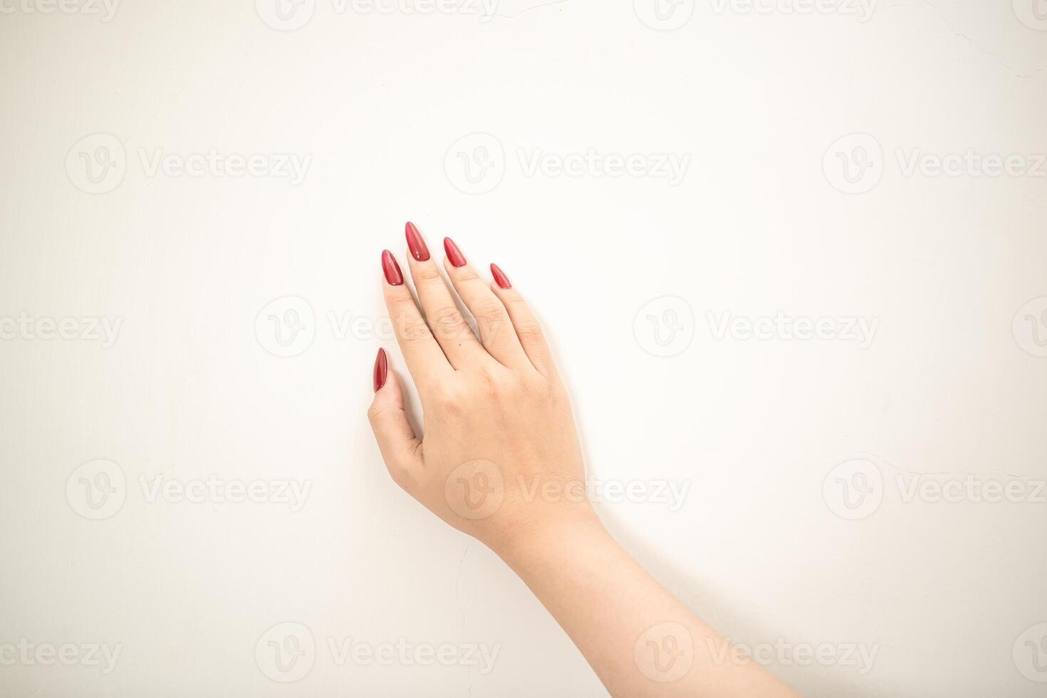 Hand use nails art pointing at something and make a sign on white background photo